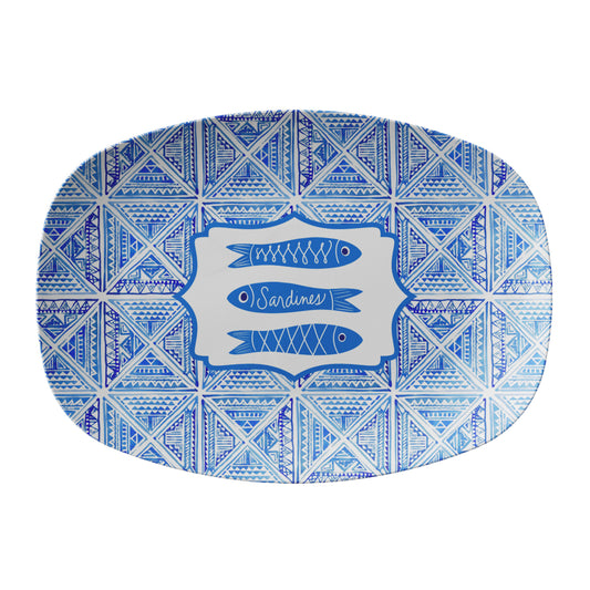 Blue and white tile patterned platter with fish design and 'Sardines' text on a white background