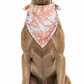 Dog wearing a personalized bandana with a sea coral pattern on a white background