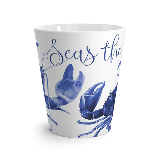 White cup with blue lobster and crab watercolor design and 'Seas the Day' text on a white background