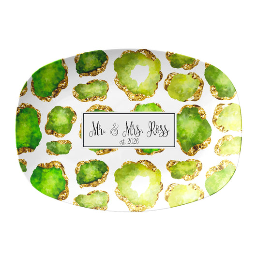 Oval serving platter has peridot green and gold crystal gemstones printed on a white background. There is a rectangle text box in the center to add any personalized name or custom text.