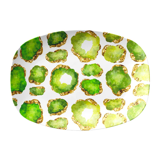 Oval serving platter has gemstone crystals in peridot green and gold printed on a white background.