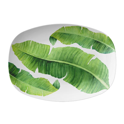 White platter with green banana leaf pattern on a white background