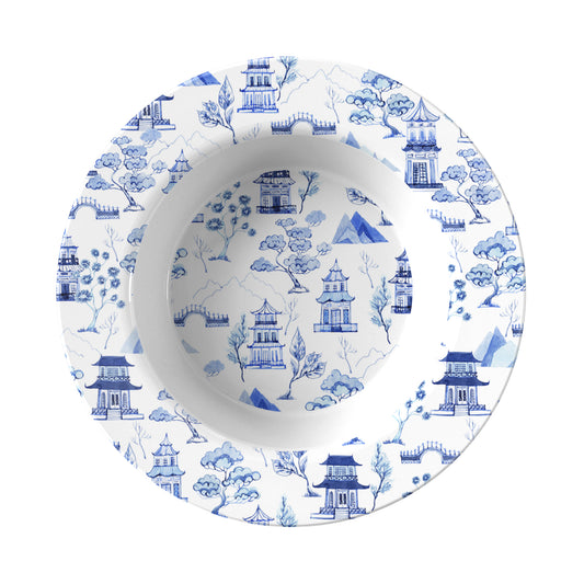 White bowl with blue architectural and nature pattern on a white background