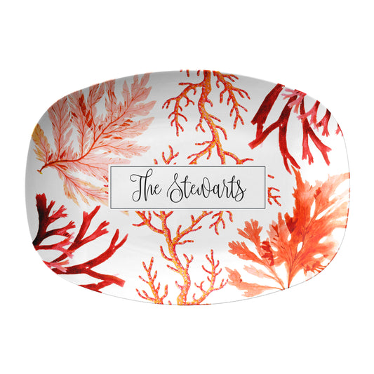 Oval serving platter with red and orange sea coral pattern and  custom text on a white background