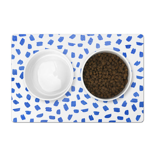 Pet food mat with blue watercolor brush strokes on white. Mat for under pet bowls.