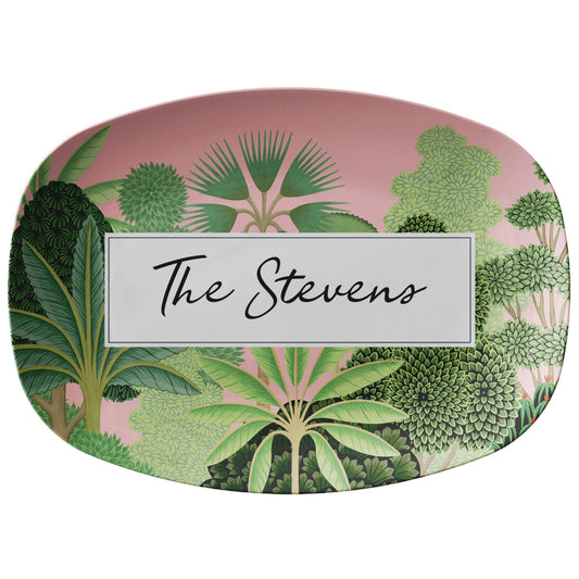 Tropical serving platter is pink and has beautiful green trees printed on it. Add any custom name or word.