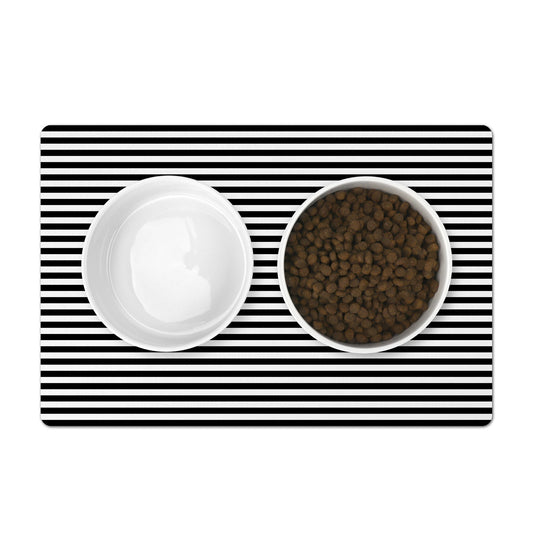 Pet food mat with black and white horizontal stripes. Mat under pet food and water bowls.
