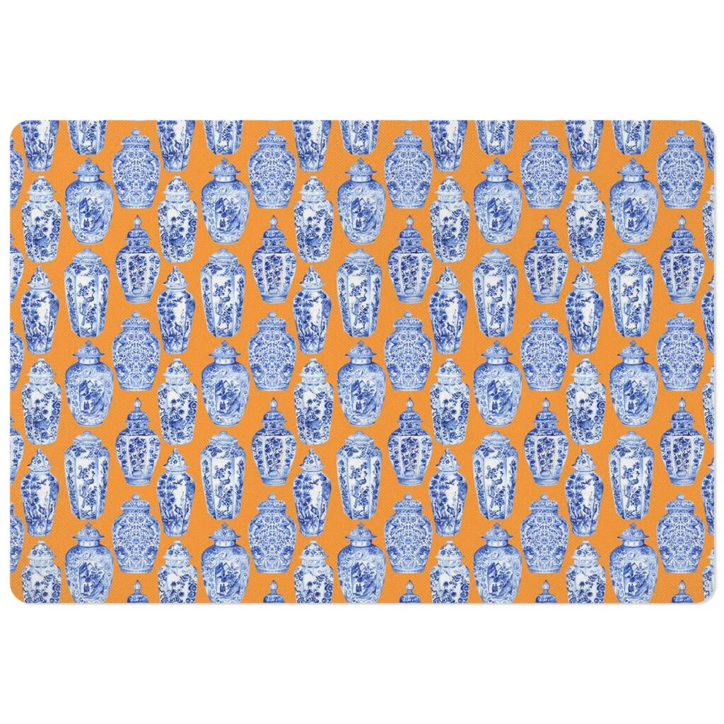 Pet feeding mat with blue and white ginger jars chinoiserie print on orange.