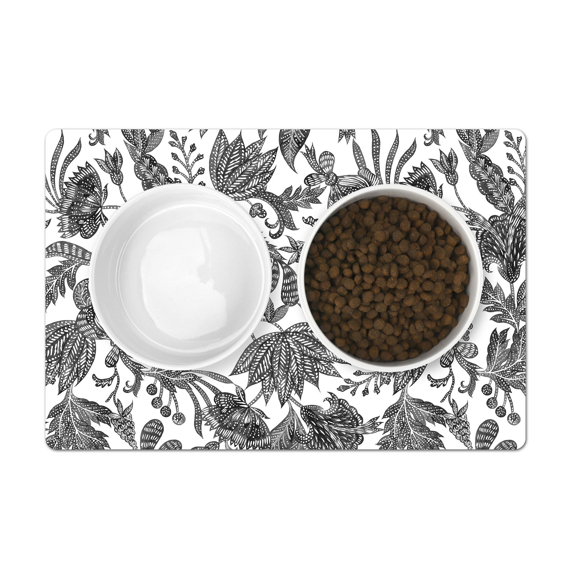 Mat for pet food bowls with a black and white floral batik print.