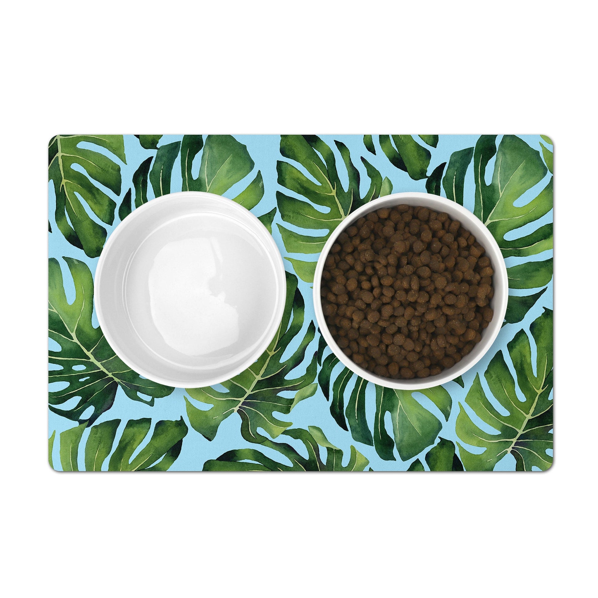 Pet food mat in aqua with green monstera leaves print to place under pet bowls.