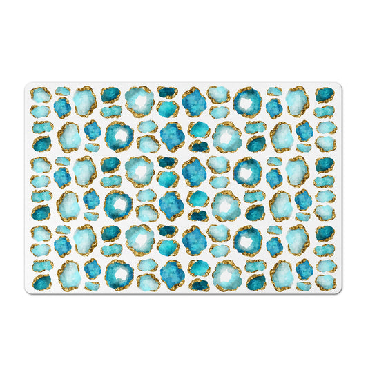 White mat for pet food with aqua and gold jewel print.