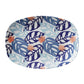 Pretty blue and white serving platter with a collage of monstera palm leaves with coral accents