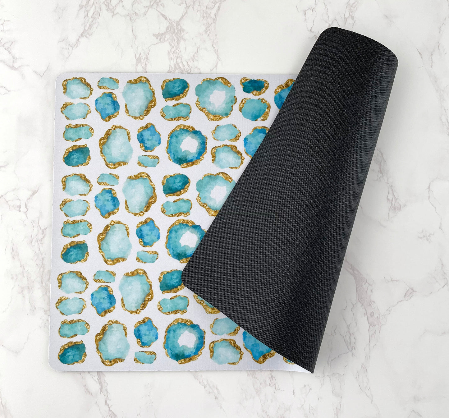 Pet bowl mat with aqua jewel print and rubberized back.