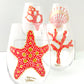 Alyssa Reuven Hand Painted Nautical Glassware. Coastal living tabletop. Set of four sea themed stemless wine glasses in coral and gold.